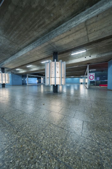 Concrete subway with blue walls and modern lighting, creates an industrial atmosphere, Munich, Germany