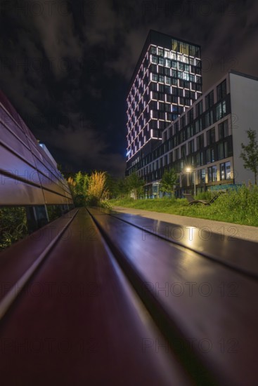 Night scene with modern buildings and unique lighting, urban atmosphere, Munich, Germany