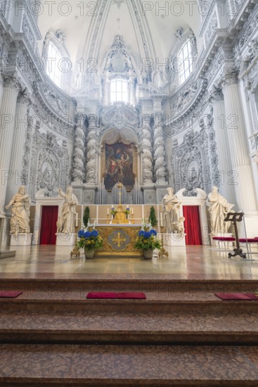 Magnificently decorated church altar in baroque architecture with sculptures and lavish ornamentation, Munich, Germany