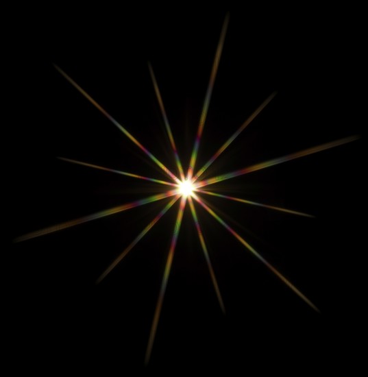 Colorful flashy spotlight star made with optical star filter on camera