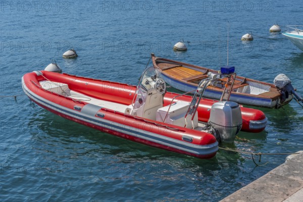 Sunny scenery including two boats at Lake Garda in Northern Italy