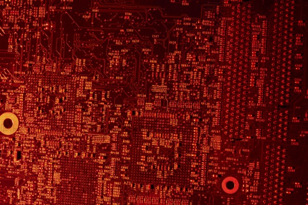Full frame red illuminated printed circuit board closeup