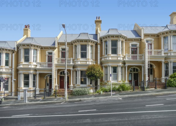Roadside scenery including some houses in Dunedin, a city at the South Island of New Zealand