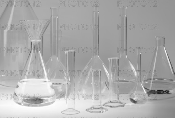 Variety of partly filled laboratory glassware