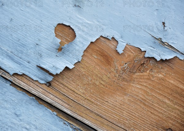 Detail of blue flaking paint on wooden surface