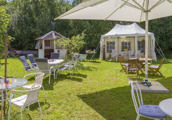Sunny illuminated idyllic scenery showing a garden prepared for party