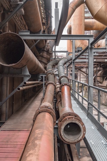 Weathered rusty industrial scenery with old corroded steel girders and metal tubes