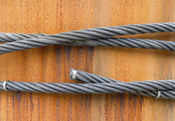 Closeup shot of wire ropes on rusty ground
