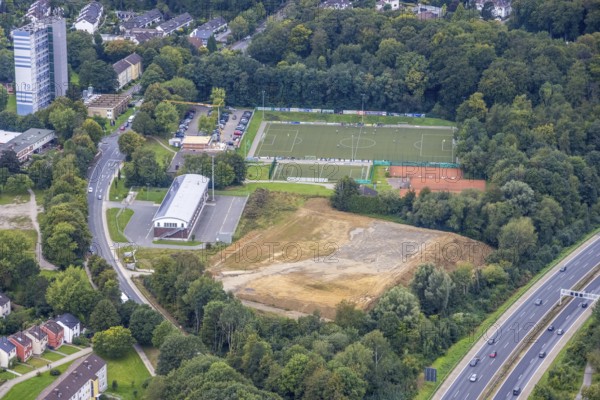 Aerial view, construction site next to the volunteer fire brigade and the Emst district sports facility on Haßleyer Straße in the Emst district of Hagen, Ruhr area, North Rhine-Westphalia, Germany, construction work, construction area, construction site, building plots, construction project, construction site, DE, Europe, football pitch, Hagen, aerial view, aerial photography, aerial photography, new construction, sports facility, sports facilities, sports field, sports facility, overview, bird's-eye view, overview