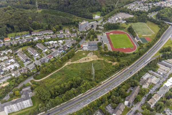 Aerial view, fallow land at the Kirchenbergstadion with planned construction of a fitness centre in the Hohenlimburg district, Hagen, Ruhr area, North Rhine-Westphalia, Germany, A46 motorway, construction area, building site, building plots, construction project, construction site, DE, Europe, football pitch, property tax, real estate, aerial view, aerial photography, aerial photography, sports, sports facilities, sports field, sports facility, overview, bird's eye view, residential complex, living and living, residential buildings, quality of living, birds-eyes view, overview