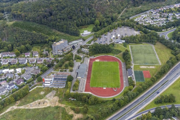 Aerial view, fallow land at the Kirchenbergstadion with planned construction of a fitness centre in the Hohenlimburg district, Hagen, Ruhr area, North Rhine-Westphalia, Germany, A46 motorway, construction area, building site, building plots, construction project, construction site, DE, Europe, football pitch, property tax, real estate, aerial view, aerial photography, aerial photography, sports, sports facilities, sports field, sports facility, overview, bird's eye view, residential complex, living and living, residential buildings, quality of living, birds-eyes view, overview