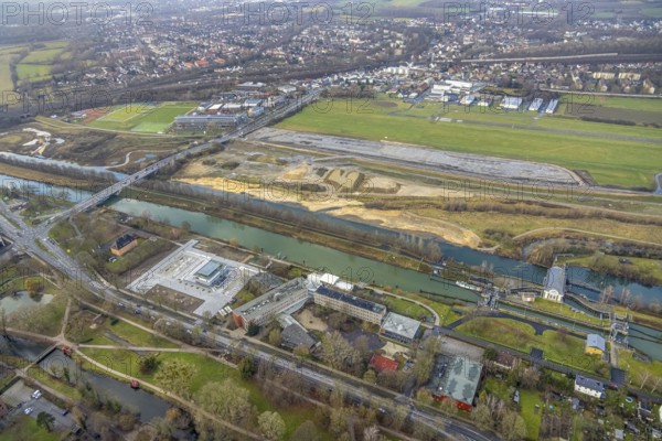 Aerial view construction area new water sports centre on Adenauerallee at Hammonense grammar school with transition to Nordring and Hans-Böckler-Platz in Hamm, Ruhr area, North Rhine-Westphalia, Germany, construction work, construction vehicles, construction area, construction site, building plots, construction crane, construction measure, construction project, construction site, education, educational institution, DE, Datteln-Hamm Canal, development, Europe, Hamm airfield, River Lippe, business park, grammar school, Hamm, industrial area, canal edge, educational institute, Lippe floodplain, aerial photograph, aerial photography, aerial photography, Rhine-Ruhr metropolitan region, new construction, shipping, Hamm lock, school, overview, bird's-eye view, overview