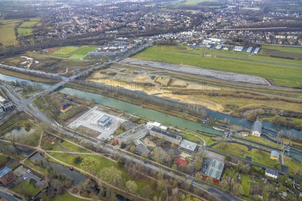 Aerial view construction area new water sports centre on Adenauerallee at Hammonense grammar school with transition to Nordring and Hans-Böckler-Platz in Hamm, Ruhr area, North Rhine-Westphalia, Germany, construction work, construction vehicles, construction area, construction site, building plots, construction crane, construction measure, construction project, construction site, education, educational institution, DE, Datteln-Hamm Canal, development, Europe, Hamm airfield, River Lippe, business park, grammar school, Hamm, industrial area, canal edge, educational institute, Lippe floodplain, aerial photograph, aerial photography, aerial photography, Rhine-Ruhr metropolitan region, new construction, shipping, Hamm lock, school, overview, bird's-eye view, overview
