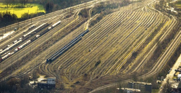 Aerial view shunting yard and freight yard in backlight in Hamm, Ruhr area, North Rhine-Westphalia, Germany, railway tracks, railway station, DE, Deutsche Bahn AG, Europe, backlight, railway tracks, Hamm, aerial view, aerial photograph, aerial photography, aerial photography, Rhine-Ruhr metropolitan region, overview, bird's eye view, birds-eyes view, former signal box, overview