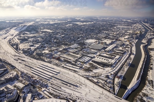 Aerial view, Hamm main station, tracks and platforms in the snow, industrial area at the harbour, Datteln-Hamm canal, winter, centre, Hamm, Ruhr area, North Rhine-Westphalia, Germany, DE, Europe, aerial view, aerial photography, aerial photography, snow, overview, bird's-eye view, view, overview, main station, railway line, railway network, infrastructure, transport, traffic, train traffic, freight traffic, railway network, federal railway, German, railway, tracks, trains, transport, traffic, rails, industrial area, industry, manufacturing, production, waterway, shipping, logistics, movement of goods, ships, water, waterways, goods, trade