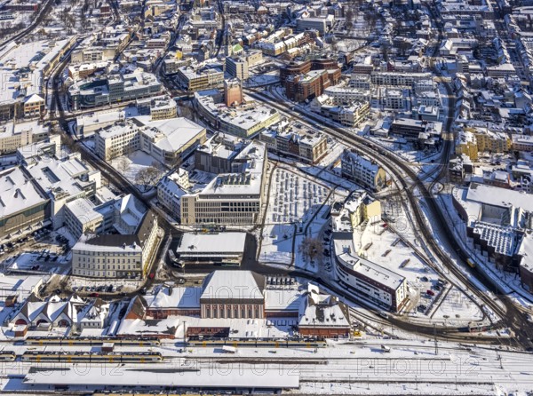 Aerial view, Hamm main station, tracks and platforms in the snow, winter, city centre, Heinrich-von-Kleist-Forum, city library, centre, Hamm, Ruhr area, North Rhine-Westphalia, Germany, DE, Europe, aerial view, aerial photography, aerial photography, snow, overview, bird's-eye view, birds-eyes, view, overview, main station, Heinrich-vin-Kleist-Forum, train traffic, railway traffic, traffic connection, travel, holiday, federal railway, German, railway, tracks, trains, transport, traffic, rails, books, media, reading, audiobooks, information, fiction, knowledge, culture, shopping