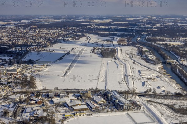 Aerial view, Hamm EDLH airfield, Lippe, Datteln-Hamm canal, bridge federal road B63 Münsterstraße, sports facility HTC Hockey- und Tennisclub Hamm, Gymnasium Hammonense, water sports centre, snow-covered areas, winter, centre, Hamm, Ruhr area, North Rhine-Westphalia, Germany, DE, Europe, aerial view, aerial photography, aerial photography, snow, overview, bird's eye view, birds-eyes, view, overview, Lippemäander, Hammonense, EDLH, waterway, shipping, transport, logistics, goods movement, ships, waters, education, pupils, college, training, school year, homework, class, year group, education, pedagogy, airfield, flying, air sports, leisure, pilot, grass pitch, artificial grass pitch, football, sport, training, football match, football pitch, hobby, championship, athlete, team, sports field, sports facility, clay court, tennis, tennis playing, tennis club