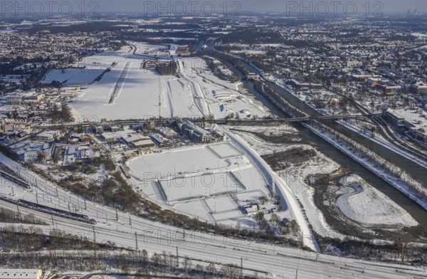 Aerial view, Hamm EDLH airfield, Lippe, Datteln-Hamm canal, bridge federal road B63 Münsterstraße, sports facility HTC Hockey- und Tennisclub Hamm, Gymnasium Hammonense, water sports centre, snow-covered areas, winter, centre, Hamm, Ruhr area, North Rhine-Westphalia, Germany, DE, Europe, aerial view, aerial photography, aerial photography, snow, overview, bird's eye view, birds-eyes, view, overview, Lippemäander, Hammonense, EDLH, waterway, shipping, transport, logistics, goods movement, ships, waters, education, pupils, college, training, school year, homework, class, year group, education, pedagogy, airfield, flying, air sports, leisure, pilot, grass pitch, artificial grass pitch, football, sport, training, football match, football pitch, hobby, championship, athlete, team, sports field, sports facility, clay court, tennis, tennis playing, tennis club