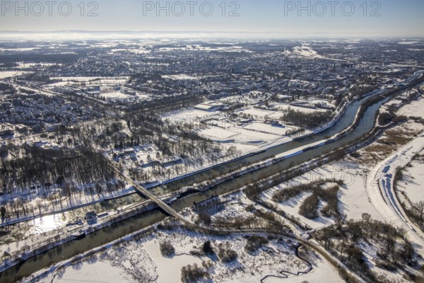 Aerial view, bridge ferry road over Lippe and Datteln-Hamm Canal, snow, winter, Heessen, Hamm, Ruhr area, North Rhine-Westphalia, Germany, DE, Europe, aerial view, aerial photography, aerial photography, overview, bird's-eye view, birds-eyes, view, overview, Lippe meander, Datteln-Hamm Canal, waterway, shipping traffic, transport, logistics, goods movement, ships, waters, traffic, infrastructure, road traffic