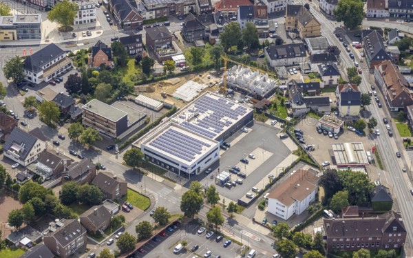 Aerial view, ALDI Nord supermarket with solar roof and construction area Heessener Gärten in Heessen, Hamm, Ruhr area, North Rhine-Westphalia, Germany, construction work, construction area, building site, building plots, construction project, construction site, DE, Europe, aerial view, aerial photography, aerial photography, new construction, photovoltaic, photovoltaic system, solar, solar system, solar roof, solar energy, overview, bird's eye view, birds-eyes view, overview
