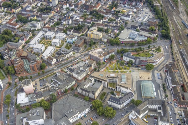 Aerial view, city centre view city with Platz der Deutschen Einheit at Hamm main station as well as construction site and new residential building on the former site of the Kippâ'¬â¢n in Bahnhofstraße in Mitte, Hamm, Ruhr area, North Rhine-Westphalia, Germany, Bahnhofstraße, construction work, construction area, construction site, building plots, construction project, construction site, bunker, DE, Europe, commercial buildings, high bunker, aerial view, aerial photography, aerial photography, new construction, square, overview, bird's-eye view, overview, city centre view City with Platz der Deutschen Einheit at Hamm main station as well as construction site and new residential building on the former site of the Kipp'™n in Bahnhofstraße in Mitte