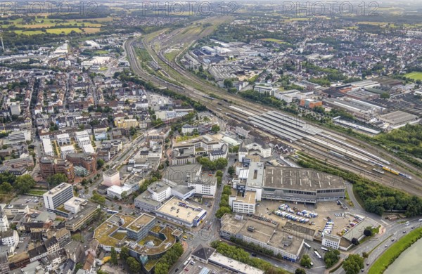 Aerial view, city centre view city with Platz der Deutschen Einheit and Hamm Westf. central station in Mitte, Hamm, Ruhr area, North Rhine-Westphalia, Germany, railway tracks, railway station, Bahnhofstraße, station forecourt, construction work, construction area, building site, building plots, construction project, construction site, DE, Deutsche Bahn AG, Europe, commercial buildings, central station, Hbf, aerial view, aerial photography, aerial photography, new building, square, overview, bird's-eye view, bird's-eye view, overview
