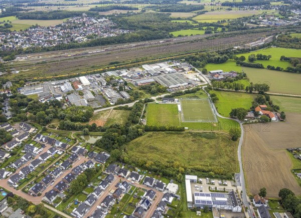 Aerial view, commercial area Schieferstraße and fallow land at the sports facility TuS Germania Lohauserholz-Daberg in the district Pelkum in Hamm, Ruhr area, North Rhine-Westphalia, Germany, DE, Europe, football pitch, commercial enterprises, commercial area, commercial area, commercial park, commercial location, commercial use, Hamm, industrial area, industrial location, aerial view, aerial photography, aerial photography, sports facilities, sports field, sports facility, overview, bird's eye view, birds-eyes view, overview