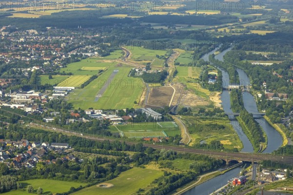 Aerial view, Hamm-Lippewiesen airfield, Lippe floodplain, Hamm lock, Lippe river, Datteln-Hamm canal, construction site for protective dam at Jupp-Eickhoff-Weg, Lippe beach, Heessen, Hamm, Ruhr area, North Rhine-Westphalia, Germany, Allee-Center Hamm, railway tracks, construction work, construction area, construction site, construction measure, construction project, construction site, DE, Europe, flight emission, airport, aircraft noise, airfield, runway, aerial photograph, aerial photography, aerial photography, North Rhine-Westphalia, runway, overview, bird's-eye view, overview