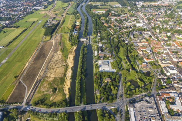 Aerial view, Hamm-Lippewiesen airfield, construction site for protective dam at Jupp-Eickhoff-Weg, Lippe beach, Lippe floodplain, Hamm lock, Lippe river, Datteln-Hamm canal, Hammonense grammar school, new water sports centre, Heessen, Hamm, Ruhr area, North Rhine-Westphalia, Germany, construction work, construction area, construction site, construction measure, construction project, construction site, education, educational institution, DE, Europe, flight emission, airport, aircraft noise, airfield, grammar school, sewage treatment plant Hamm Lippeverband, runway, educational institute, aerial photograph, aerial photography, aerial photography, North Rhine-Westphalia, school, runway, overview, bird's-eye view, overview