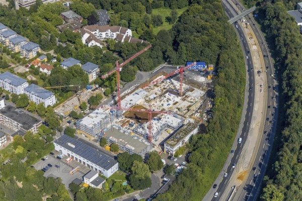 Aerial view, construction site and new construction of apartment buildings on Manfredstraße and construction site on the A52 motorway in Essen-Rüttenscheid, Essen, Ruhr area, North Rhine-Westphalia, Germany, motorway, construction work, construction area, construction site, building plots, construction crane, construction project, construction site, DE, Europe, property of the former Paas forwarding company, aerial view, aerial photography, aerial photography, new construction, overview, bird's-eye view, overview