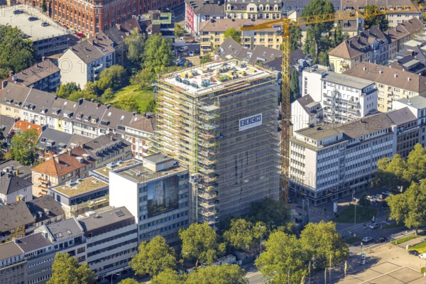 Aerial view, construction site, new building complex with residential tower and senior citizens' flats on Huyssenallee in the Südviertel in Essen, Ruhr area, North Rhine-Westphalia, Germany, expansion areas, construction work, construction, construction area, construction site, construction crane, construction measure, construction project, construction site, care and nursing, DE, renewal, development, Essen, Europe, capacity requirements, aerial view, aerial photography, aerial photography, new build, care facility, retirement home, retirement centre, overview, bird's-eye view, becoming and growing, birds-eyes view, overview