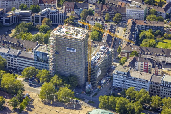Aerial view, construction site, new building complex with residential tower and senior citizens' flats on Huyssenallee in the Südviertel in Essen, Ruhr area, North Rhine-Westphalia, Germany, expansion areas, construction work, construction, construction area, construction site, construction crane, construction measure, construction project, construction site, care and nursing, DE, renewal, development, Essen, Europe, capacity requirements, aerial view, aerial photography, aerial photography, new build, care facility, retirement home, retirement centre, overview, bird's-eye view, becoming and growing, birds-eyes view, overview