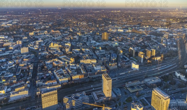 Aerial view, city centre view with central station in the city centre in Essen, Ruhr area, North Rhine-Westphalia, Germany, evening light, railway tracks, railway station, office buildings, City, DE, Deutsche Bahn AG, Essen, Europe, commercial buildings, central station, main station, city centre, aerial view, aerial photography, aerial photography, location view, skyline, townscape, city centre, city centre, overview, bird's eye view, birds-eyes view, overview