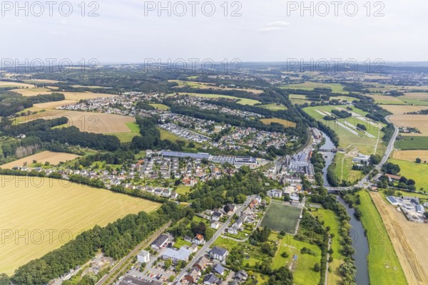 Aerial view, Schürenfeld planned industrial area at the federal road B233 Unnaer Straße in the district Dellwig, view to the district Langschede and Ardey, Wasserwerke Westfalen GmbH city limits Menden, Fröndenberg/Ruhr, Ruhr area, North Rhine-Westphalia, Germany, car repair shop, DE, Europe, commercial enterprises, commercial area, commercial area, commercial site, commercial use, industrial area, industrial building, industrial site, landscape conservation area, aerial view, aerial photography, aerial photography, Menden, nature reserve, nature reserve Strickherdicker Bachtal, overview, bird's-eye view, birds-eyes view, overview