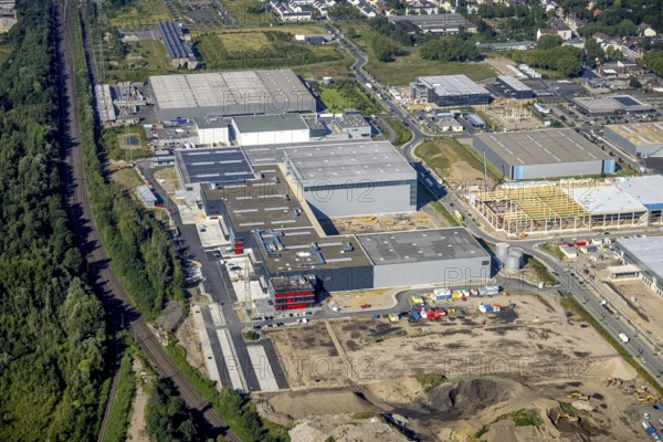 Aerial view, construction site commercial area and industrial park Schalker Verein on Europastrasse with bilstein group logistics centre in the Bulmke-Hüllen district in Gelsenkirchen, Ruhr area, North Rhine-Westphalia, Germany, construction work, building, construction area, building site, building plots, construction project, construction site, DE, Europe, Gelsenkirchen, commercial enterprises, commercial area, commercial area, commercial park, commercial site, commercial use, industrial area, industrial building, industrial site, logistics, logistics service, logistics service provider, logistics provider, logistics centre, aerial view, aerial photography, aerial photography, new construction, overview, bird's-eye view, former blast furnace site Schalker Verein, overview