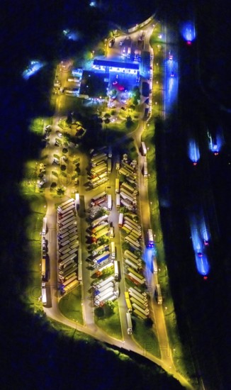 Aerial photo, motorway service area Resser Mark, Resse, Gelsenkirchen, Ruhr area, North Rhine-Westphalia, Germany, motorway A2, DE, twilight photography, Europe, shapes and colours, truck parking, tracers, light pollution, aerial photography, aerial photography, night, night photography, night flight, parking, road traffic, overview, bird's eye view, illuminated road traffic, birds-eyes view, nightflight, overview