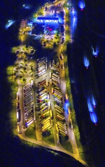 Aerial photo, motorway service area Resser Mark, Resse, Gelsenkirchen, Ruhr area, North Rhine-Westphalia, Germany, motorway A2, DE, twilight photography, Europe, shapes and colours, truck parking, tracers, light pollution, aerial photography, aerial photography, night, night photography, night flight, parking, road traffic, overview, bird's eye view, illuminated road traffic, birds-eyes view, nightflight, overview
