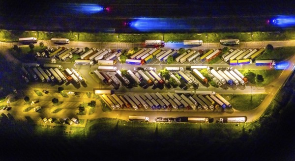Aerial photo, motorway service area Resser Mark, Resse, Gelsenkirchen, Ruhr area, North Rhine-Westphalia, Germany, motorway A2, DE, twilight photography, Europe, shapes and colours, truck parking, tracers, light pollution, aerial photography, aerial photography, night, night photography, night flight, parking, road traffic, overview, bird's eye view, illuminated road traffic, birds-eyes view, nightflight, overview