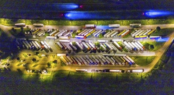 Aerial photo, motorway service area Resser Mark, Resse, Gelsenkirchen, Ruhr area, North Rhine-Westphalia, Germany, motorway A2, DE, twilight photography, Europe, shapes and colours, truck parking, tracers, light pollution, aerial photography, aerial photography, night, night photography, night flight, parking, road traffic, overview, bird's eye view, illuminated road traffic, birds-eyes view, nightflight, overview
