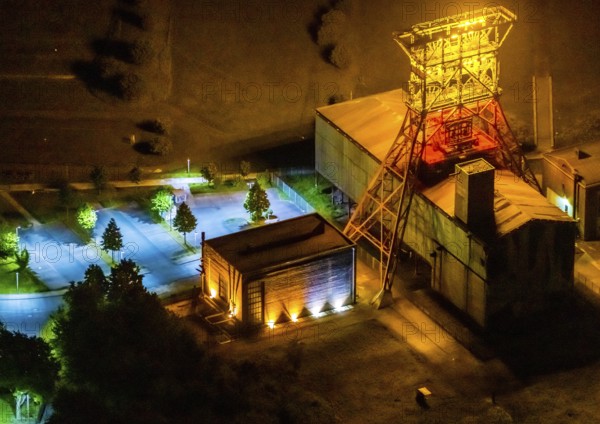 Aerial view, headframe shaft IX with engine houses in Consol Park, Bismarck, Gelsenkirchen, Ruhr area, North Rhine-Westphalia, Germany, Consol Yellow Art, DE, twilight photography, Europe, headframe, winding tower, light art installation, light pollution, aerial view, aerial photography, aerial photography, north engine house, south engine house, night, night shot, night flight, overview, bird's eye view, Consolidation colliery, illuminated streets, birds-eyes view, nightflight, overview