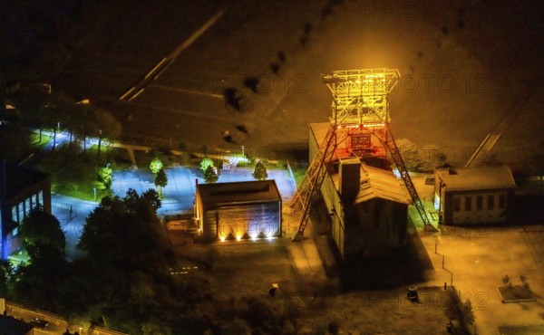 Aerial view, headframe shaft IX with engine houses in Consol Park, Bismarck, Gelsenkirchen, Ruhr area, North Rhine-Westphalia, Germany, Consol Yellow Art, DE, twilight photography, Europe, headframe, winding tower, light art installation, light pollution, aerial view, aerial photography, aerial photography, north engine house, south engine house, night, night shot, night flight, overview, bird's eye view, Consolidation colliery, illuminated streets, birds-eyes view, nightflight, overview