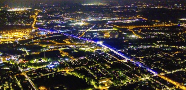 Aerial view, illumination in Schalke blue, Schalke 04, Kurt-Schumacher Straße with thyssenkrupp Electrical Steel GmbH, Schalke, Gelsenkirchen, Ruhr area, North Rhine-Westphalia, Germany, DE, twilight photography, Europe, commercial enterprises, commercial area, commercial park, commercial location, commercial use, industrial area, industrial site, light pollution, aerial view, aerial photography, aerial photography, night, night photography, night flight, overview, bird's-eye view, illuminated streets, birds-eyes view, blue band, blue light, artificial light, nightflight, overview