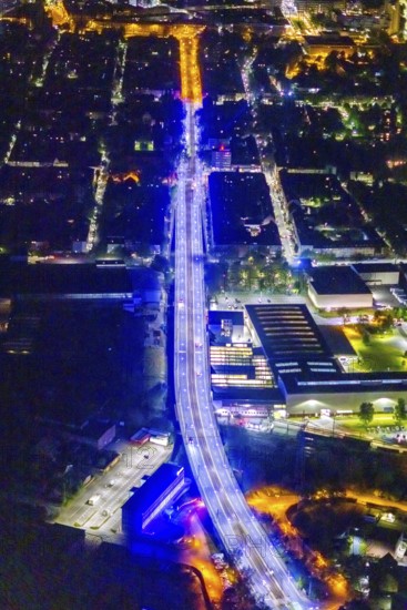 Aerial view, illumination in Schalke blue, Schalke 04, Kurt-Schumacher Straße with thyssenkrupp Electrical Steel GmbH, Schalke, Gelsenkirchen, Ruhr area, North Rhine-Westphalia, Germany, DE, twilight photography, Europe, commercial enterprises, commercial area, commercial park, commercial location, commercial use, industrial area, industrial site, light pollution, aerial view, aerial photography, aerial photography, night, night photography, night flight, overview, bird's-eye view, illuminated streets, birds-eyes view, blue band, blue light, artificial light, nightflight, overview