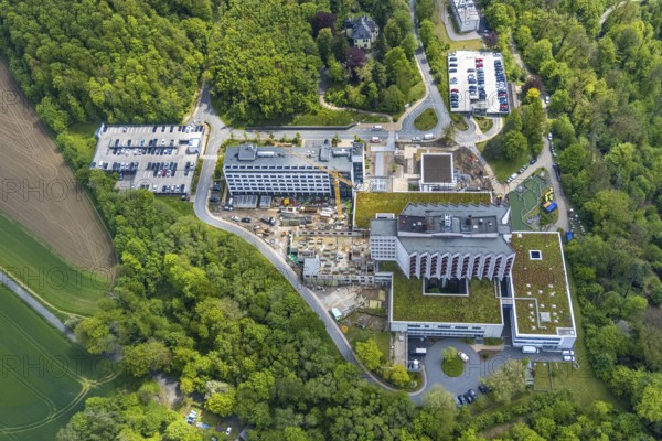 Aerial view, Ruhrlandklinik with construction site, Essen-Heidhausen, Essen, Ruhr area, North Rhine-Westphalia, Germany, construction work, construction area, construction site, building plots, construction crane, construction measure, construction project, construction site, DE, Europe, specialist clinic, healthcare, hospital, clinic, clinic centre, hospital, aerial photograph, aerial photography, aerial photography, medical facility, medical aid, new building, emergency service, Tüschener Weg, overview, bird's eye view, birds-eyes view, overview, medical care