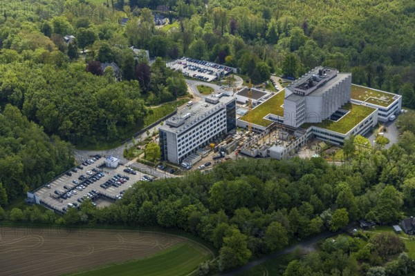 Aerial view, Ruhrlandklinik with construction site, Essen-Heidhausen, Essen, Ruhr area, North Rhine-Westphalia, Germany, construction work, construction area, construction site, building plots, construction crane, construction measure, construction project, construction site, DE, Europe, specialist clinic, healthcare, hospital, clinic, clinic centre, hospital, aerial photograph, aerial photography, aerial photography, medical facility, medical aid, new building, emergency service, Tüschener Weg, overview, bird's eye view, birds-eyes view, overview, medical care