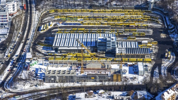 Aerial view, construction site, new hall construction Ruhrbahn depot, city centre, Essen, Ruhr area, North Rhine-Westphalia, Germany, construction work, construction area, construction site, building plots, construction project, construction site, bus station, DE, Europe, aerial view, aerial photography, aerial photography, new building, snow, tramway, overview, bird's eye view, winter, birds-eyes view, overview