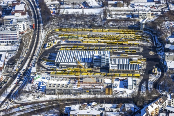 Aerial view, construction site, new hall construction Ruhrbahn depot, city centre, Essen, Ruhr area, North Rhine-Westphalia, Germany, construction work, construction area, construction site, building plots, construction project, construction site, bus station, DE, Europe, aerial view, aerial photography, aerial photography, new building, snow, tramway, overview, bird's eye view, winter, birds-eyes view, overview