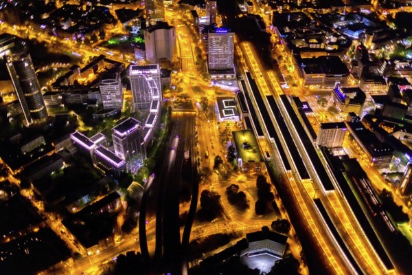 Aerial view, Essen central station, southern district, Essen, Ruhr area, North Rhine-Westphalia, Germany, outdoor lighting, railway station, DE, Deutsche Bahn AG, twilight, Europe, commercial buildings, central station, main station, light pollution, aerial photograph, aerial photography, aerial photography, night aerial photograph, streetlights, street lamps, overview, bird's eye view, illuminated, illuminated houses, illuminated house, birds-eyes view, artificial light, night, nightflight, overview