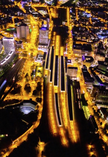 Aerial view, Essen central station, eastern district, Essen, Ruhr area, North Rhine-Westphalia, Germany, outdoor lighting, railway station, DE, Deutsche Bahn AG, twilight, Europe, commercial buildings, central station, main station, light pollution, aerial photograph, aerial photography, aerial photography, night aerial photograph, streetlights, street lamps, overview, bird's eye view, illuminated, illuminated houses, illuminated house, birds-eyes view, artificial light, night, nightflight, overview