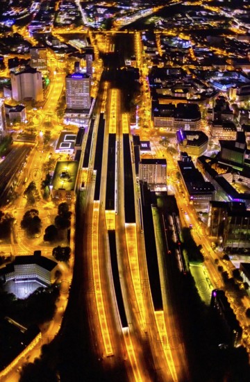 Aerial view, Essen central station, south-east quarter, Essen, Ruhr area, North Rhine-Westphalia, Germany, outdoor lighting, railway station, DE, Deutsche Bahn AG, twilight, Europe, commercial buildings, central station, main station, light pollution, aerial photograph, aerial photography, aerial photography, night aerial photograph, streetlights, street lamps, overview, bird's eye view, illuminated, illuminated houses, illuminated house, birds-eyes view, artificial light, night, nightflight, overview